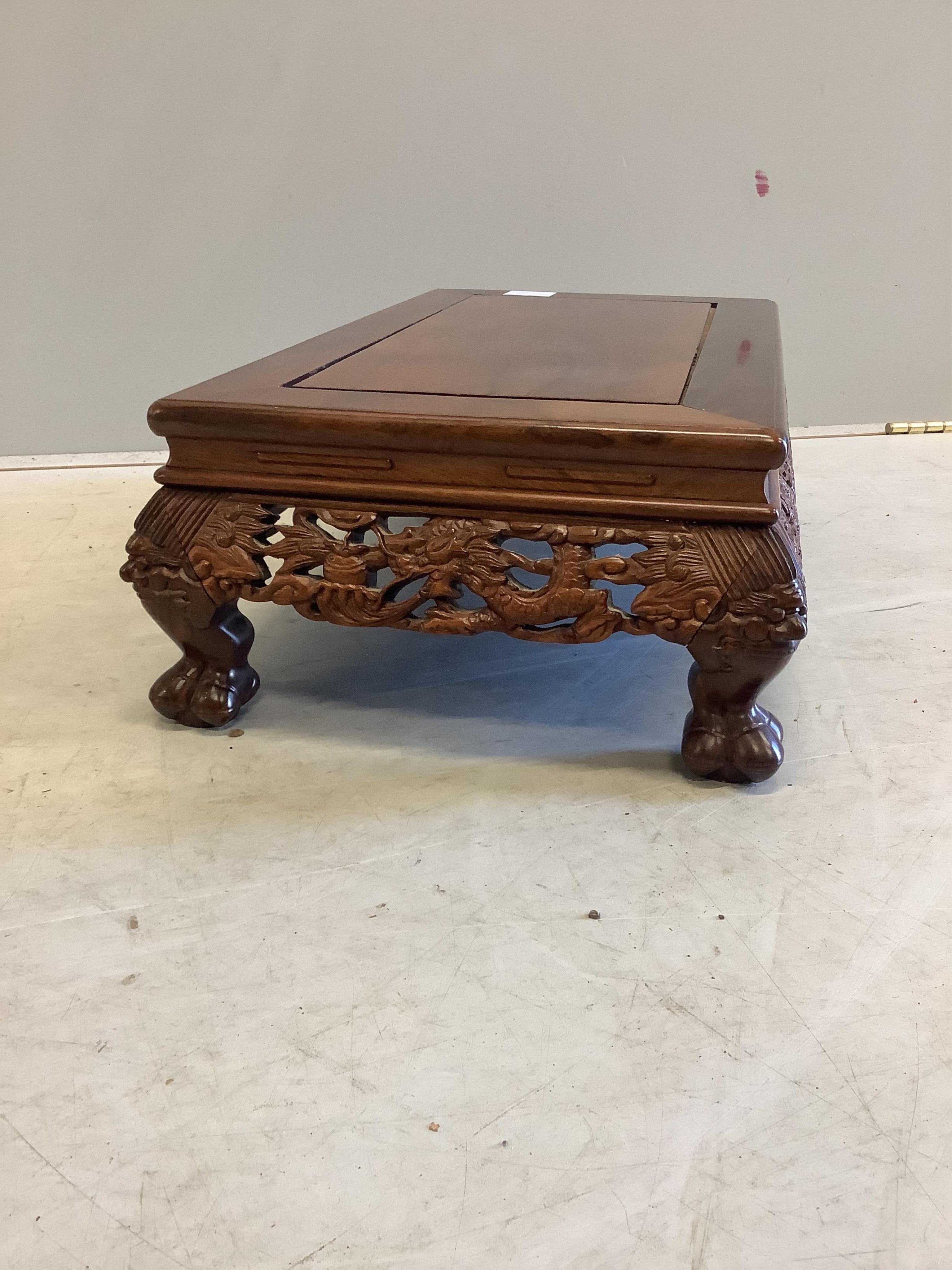 A Chinese rectangular rosewood stand or low table, width 56cm, depth 33cm, height 18cm. Condition - good